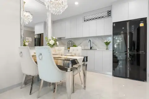 1 Bedroom Condo for Sale at Copacabana Coral Reef dining table and modern kitchen with marble backsplash and black fridge