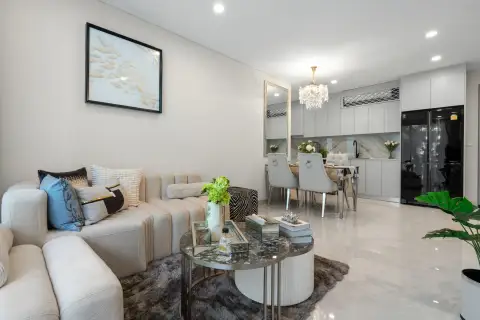 1 Bedroom Condo for Sale at Copacabana Coral Reef living room with fish artwork opening to dining area and kitchen