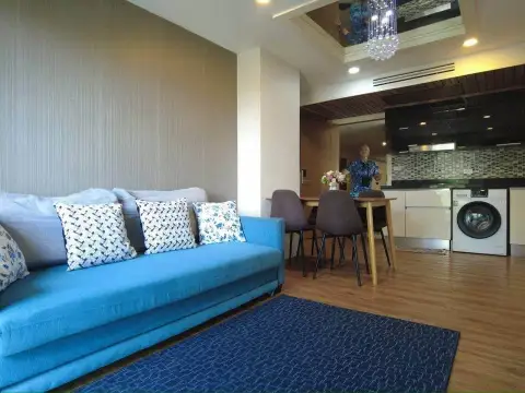 2 Bedroom Condo for Sale at Dusit Grand Park 1 blue sofa seating area beside dining table and kitchenette