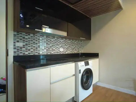 2 Bedroom Condo for Sale at Dusit Grand Park 1 compact kitchen with black countertop and built-in washing machine