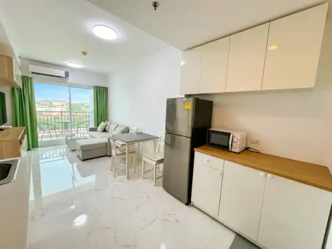 1 Bedroom Condo for Sale at Supalai Mare Pattaya kitchenette with refrigerator and living room balcony view