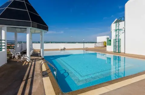 Thian Tong Condotel rooftop swimming pool with gazebo and city skyline view