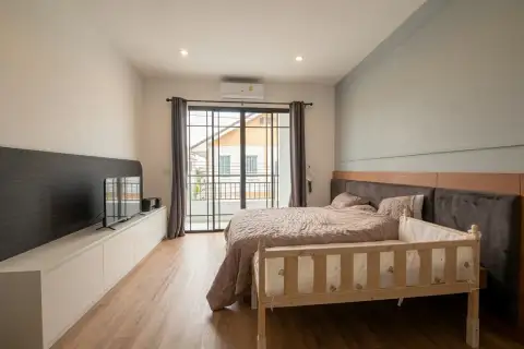 3 Bedroom House for Sale at Glam Boonsampan 6 master bedroom with balcony access and wooden flooring