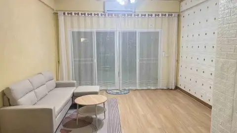 2 Bedroom Townhouse for Rent in East Pattaya living room with sheer curtains, sofa, and wood-look flooring