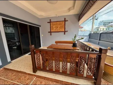 3 Bedroom Townhouse for Rent in East Pattaya outdoor balcony with wooden table, bench, and elephant wall art