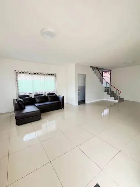 3 Bedroom House for Sale in East Pattaya living room with sofa, staircase, and large windows