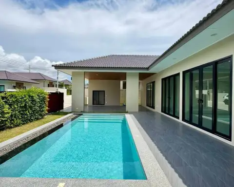 3 Bedroom House for Sale in East Pattaya side view of swimming pool with covered carport and patio