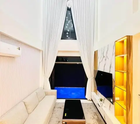3 Bedroom House for Sale & Rent in East Pattaya living room with high ceiling, floor-to-length curtains, and pool view window