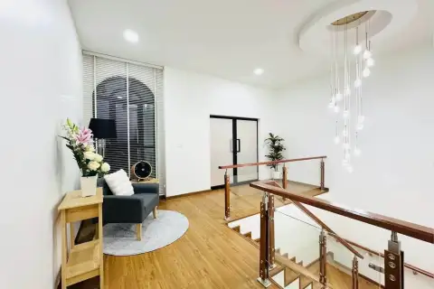 3 Bedroom House for Sale & Rent in East Pattaya upstairs landing with wooden floors, staircase, and pendant lighting