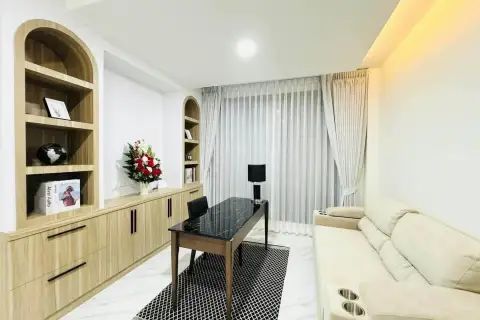 3 Bedroom House for Sale & Rent in East Pattaya cozy study area with built-in wooden shelving and marble desk