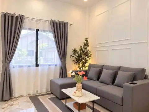 3 Bedroom House for Sale in East Pattaya living room with gray sofa, marble coffee table and sheer curtains