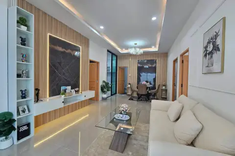 3 Bedroom House for Sale in East Pattaya spacious living and dining area with beige sofa and chandelier