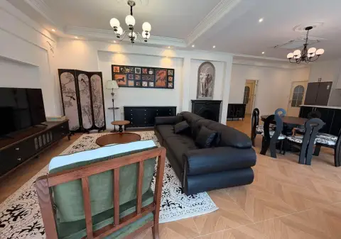 4 Bedroom House for Sale & Rent in East Pattaya living area with dining table, TV unit and decorative wall art