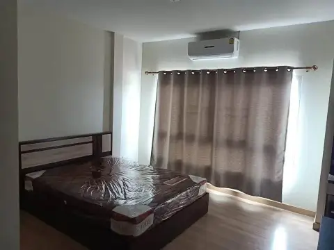 2 Bedroom Townhouse for Rent in East Pattaya bedroom with mattress, air conditioning unit and curtained window