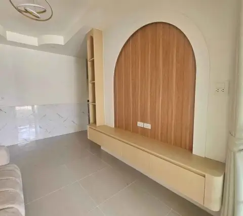 2 Bedroom Townhouse for Sale in East Pattaya close-up of arched wooden TV wall unit with built-in shelving and cabinet