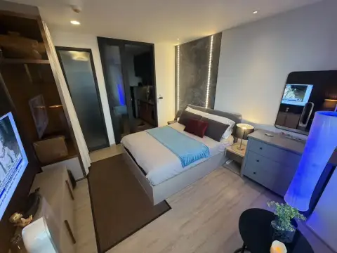 Studio Condo for Rent at EDGE Central Pattaya open-plan studio layout with bed, kitchenette, and TV