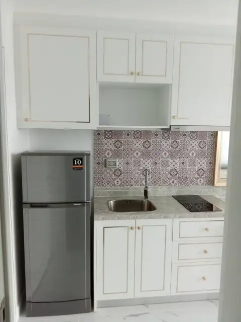 Studio Condo for Sale at The Empire Tower Pattaya compact kitchen with fridge, sink and stovetop