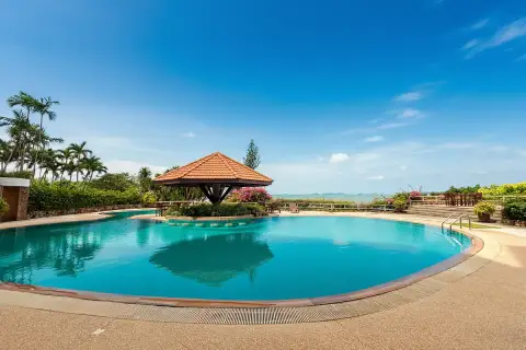 Garden Cliff Condominium 1 stunning panoramic ocean view from a cliffside with vibrant pink bougainvillea.
