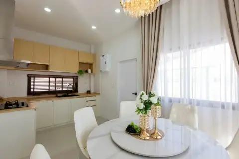 3 Bedroom House for Rent at Pattaya Green Ville dining table with kitchen counter and wooden cabinets