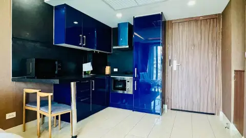 1 Bedroom Condo for Sale at Grand Avenue Residence compact kitchen with blue cabinetry near entrance door