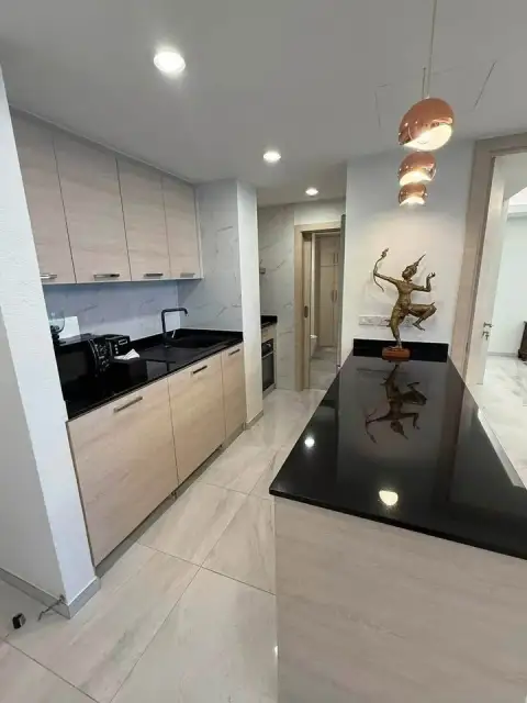 1 Bedroom Condo for Sale at Grand Condotel modern kitchen with black countertops and marble backsplash