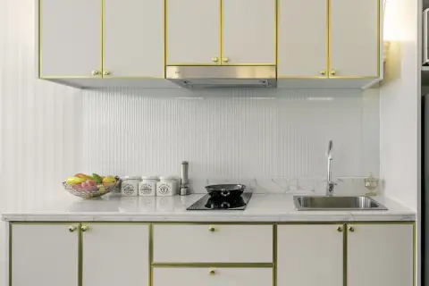 1 Bedroom Condo for Sale at Grand Florida Beachfront Condo Resort Pattaya kitchenette with marble countertop and gold-trim cabinets