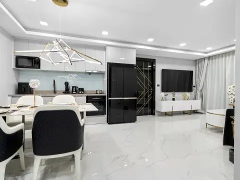 4 Bedroom Condo for Sale at Grand Solaire Noble bed with marble headboard wall and evening city view