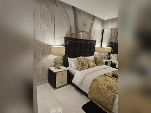 Studio Condo for Sale at Grand Solaire Noble open layout showing dining table, bed, and en-suite bathroom