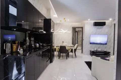 2 Bedroom Condo for Sale at Grand Solaire Pattaya black marble kitchen counter beside dining and living space