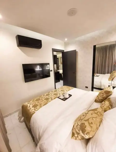 1 Bedroom Condo for Sale at Grand Solaire Pattaya bedroom with wall-mounted TV, air conditioning and mirrored closet