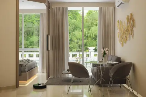 1 Bedroom Condo for Sale at Harmonia City Garden living area with dining table, gray sofa chairs and balcony overlooking tropical garden