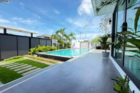 4 Bedroom House for Sale in Huai Yai showing poolside patio, lawn pathway and glass sliding doors
