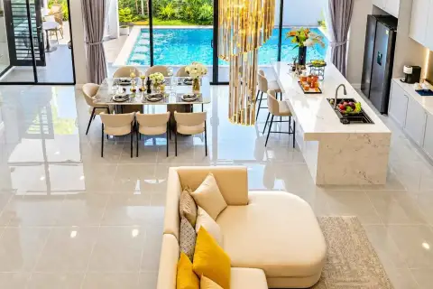 4 Bedroom House for Rent in Huai Yai open-plan living, dining and kitchen area with pool view