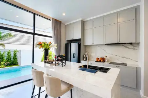 4 Bedroom House for Rent in Huai Yai modern kitchen with marble countertops and pool view window