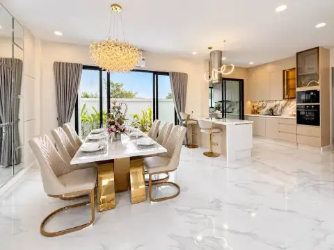 5 Bedroom House for Sale & Rent in Huai Yai open-plan dining area and kitchen with marble island and gold accents