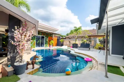 5 Bedroom House for Sale & Rent in Huai Yai poolside patio with lounge chairs, pool float, and garden wall decor