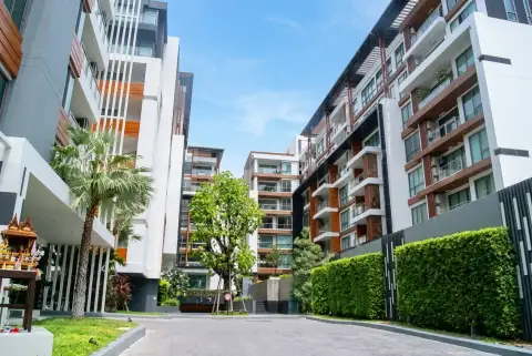 The Urban Pattaya condo entrance driveway framed by modern residential towers and gardens