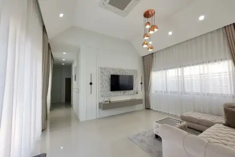 3 Bedroom House for Rent at Pattaya Green Ville living room with TV wall unit and copper pendant lights