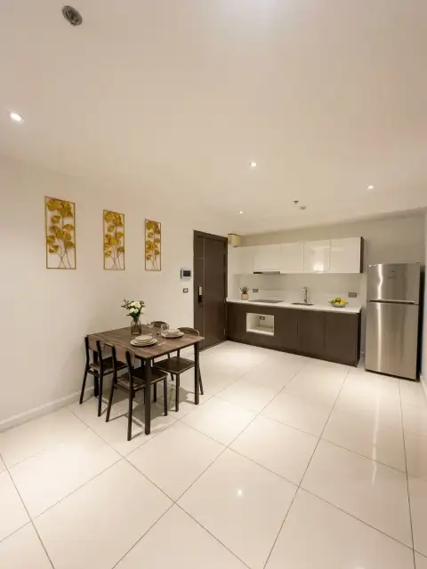 1 Bedroom Condo for Sale at The Point Pratumnak open kitchen with dining table and stainless fridge
