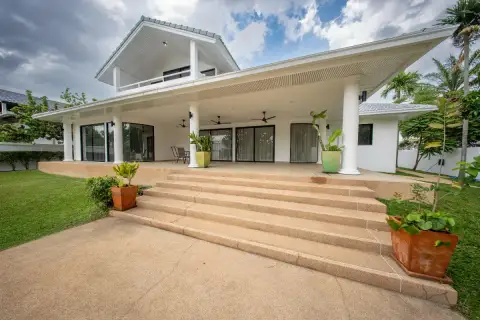 4 Bedroom House for Sale in Nong Prue featuring a covered patio with columns and wide steps leading to the lawn.