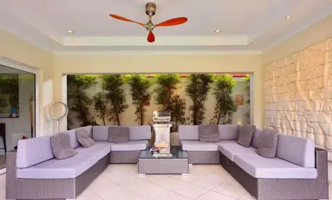 6 Bedroom House for Rent in Jomtien covered patio lounge with purple sectional sofas and ceiling fan