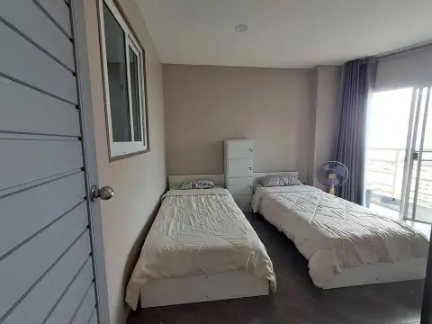 2 Bedroom Condo for Sale at Jomtien Beach Condominium twin bedroom with two single beds and balcony access
