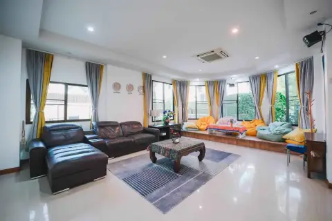 7 Bedroom House for Rent in Jomtien spacious living room with leather sofas, bean bags, and large windows