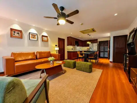 2 Bedroom Condo for Sale at Jomtien Plaza Condotel living room with leather sofa and view into kitchen