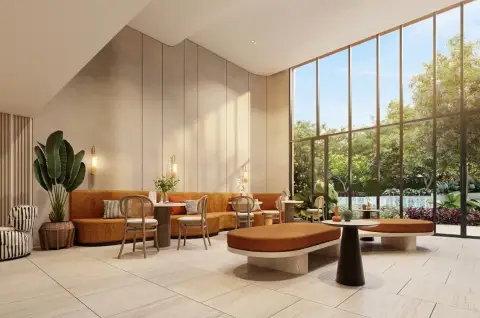 Dcondo Vale Sriracha lounge area with orange sofas, rattan chairs, and floor-to-ceiling garden view windows