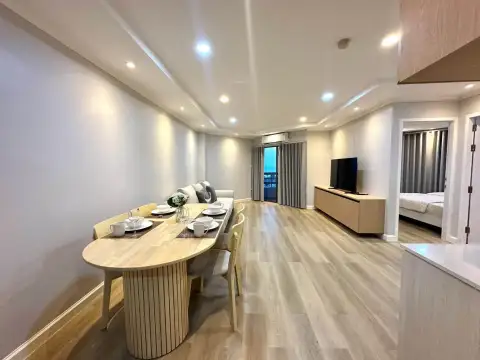 2 Bedroom Condo for Rent at Kieng Talay long living and dining space with TV unit and bedroom entrance