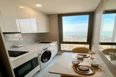 1 Bedroom Condo for Rent at Copacabana Beach Jomtien modern white kitchen with marble countertop dining area and sea view
