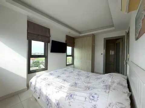 1 Bedroom Condo for Sale at Laguna Beach Resort 1 bedroom with wall-mounted TV, windows, and wardrobe closet