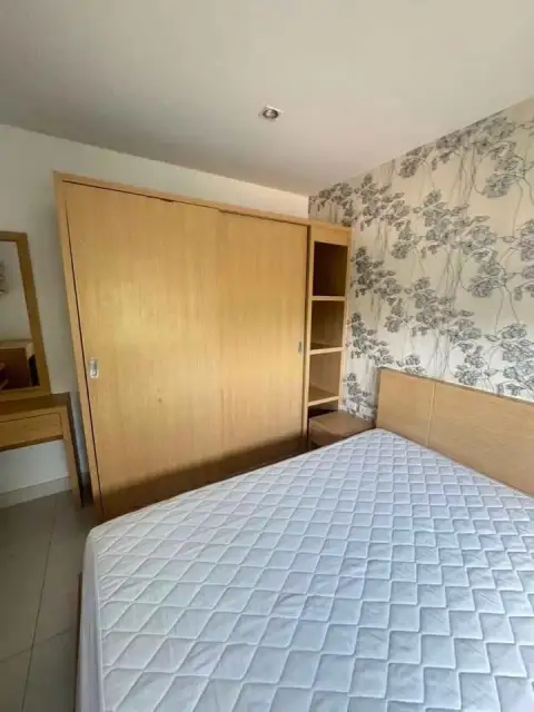 2 Bedroom Condo for Rent at Lanna Condo bedroom with sliding wardrobe closet and floral patterned wallpaper