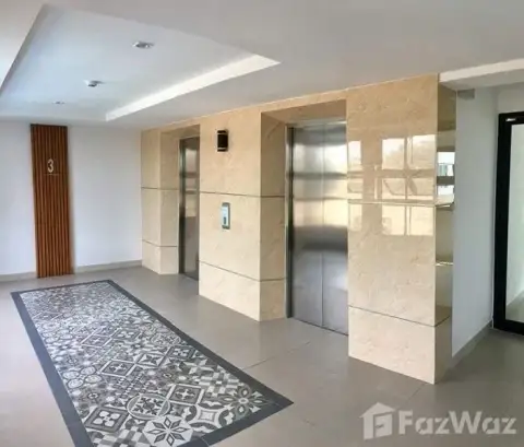 Lanna Condo bathroom with vanity sink, toilet, and glass shower stall in Pattaya